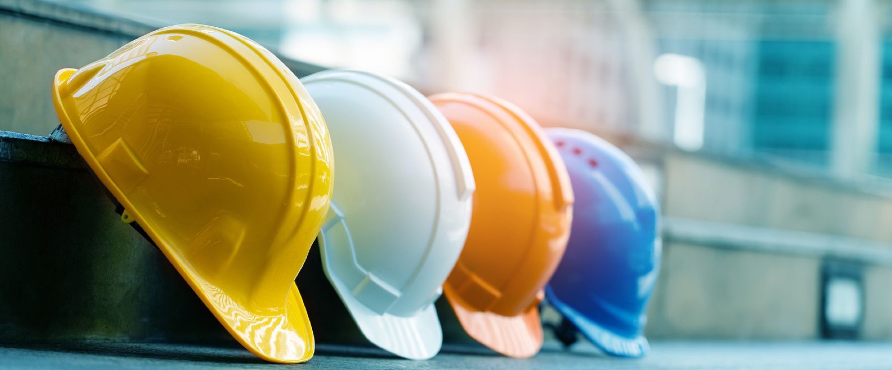 A row of hard hats on a shelf